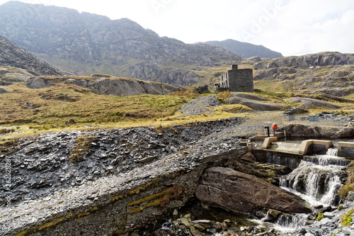 Ruins of a stone house on the Cwmorthin Waterfall trail in the mountains of Snowdonia National Park, Wales.