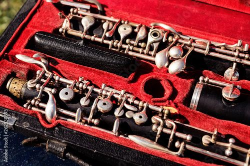 Musical wind instrument oboe in original red case.