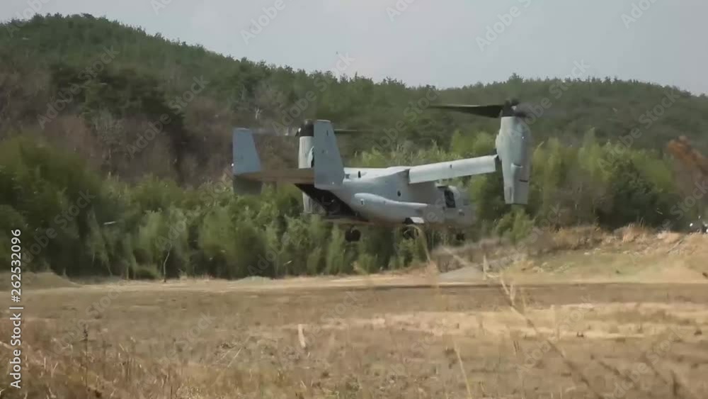 Bell Boeing V-22 Osprey arriving in open field Bell Boeing V-22 Osprey arriving in open field