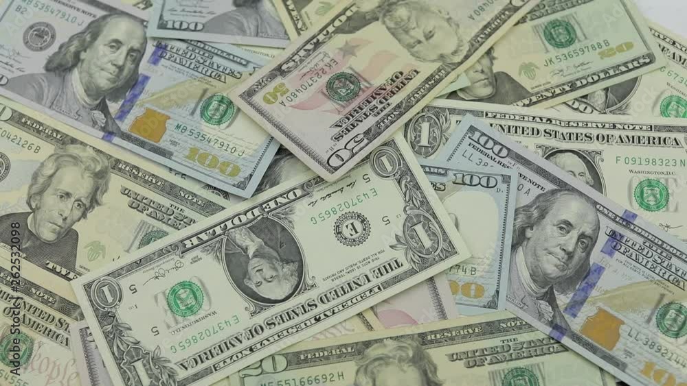 Dollar bills fall on the table with American dollars of different denominations Dollar bills fall on the table with American dollars of different denominations