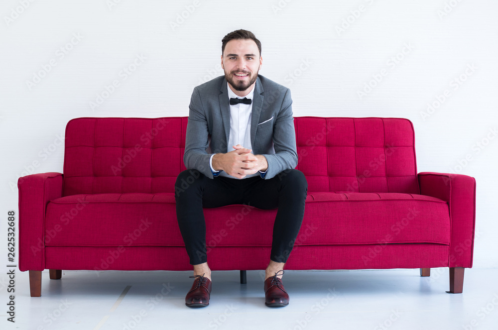 Young groom with bearded standing and smiling in formal tuxedo and suit in wedding day on white background,Copy space for text