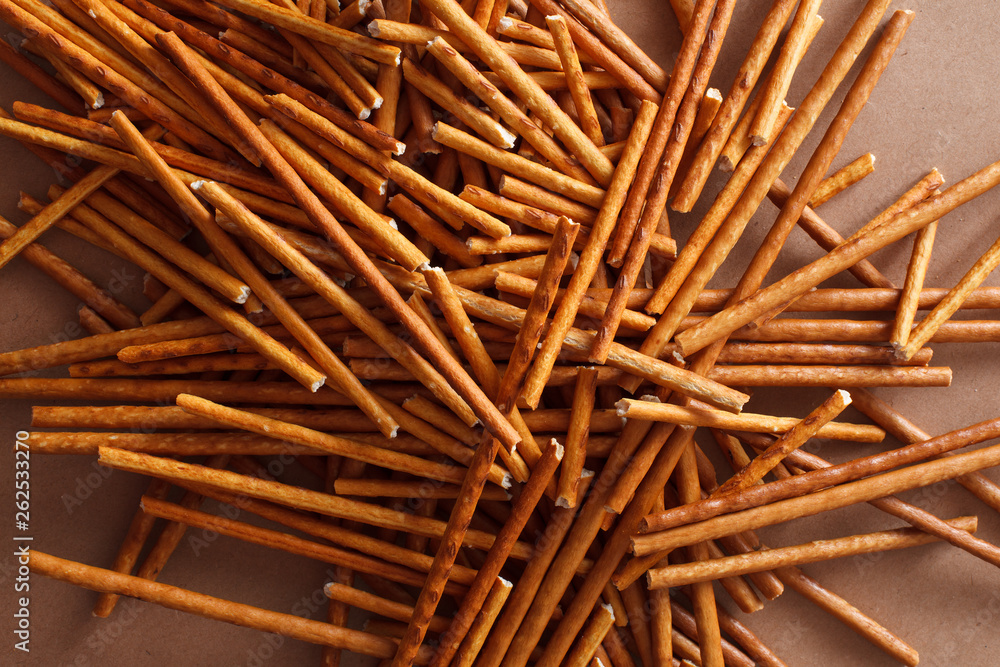 Crispy bread straw on brown paper background Crispy bread straw on brown paper background