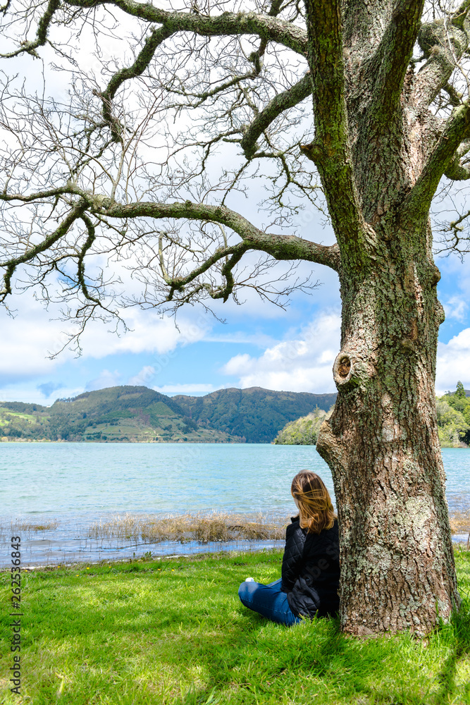 Girl looking over Sete Cidades lake into the mountains, Azores, Portugal. Girl looking over Sete Cidades lake into the mountains, Azores, Portugal.