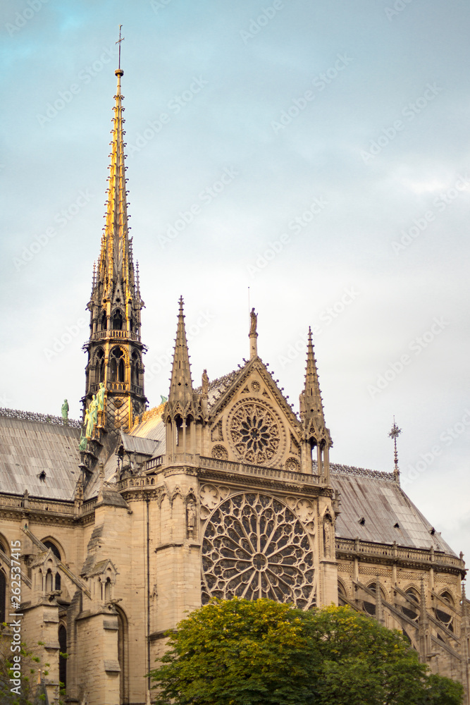 Gorgeous sunset over Notre Dame cathedral with puffy clouds, Paris, France Gorgeous sunset over Notre Dame cathedral with puffy clouds, Paris, France