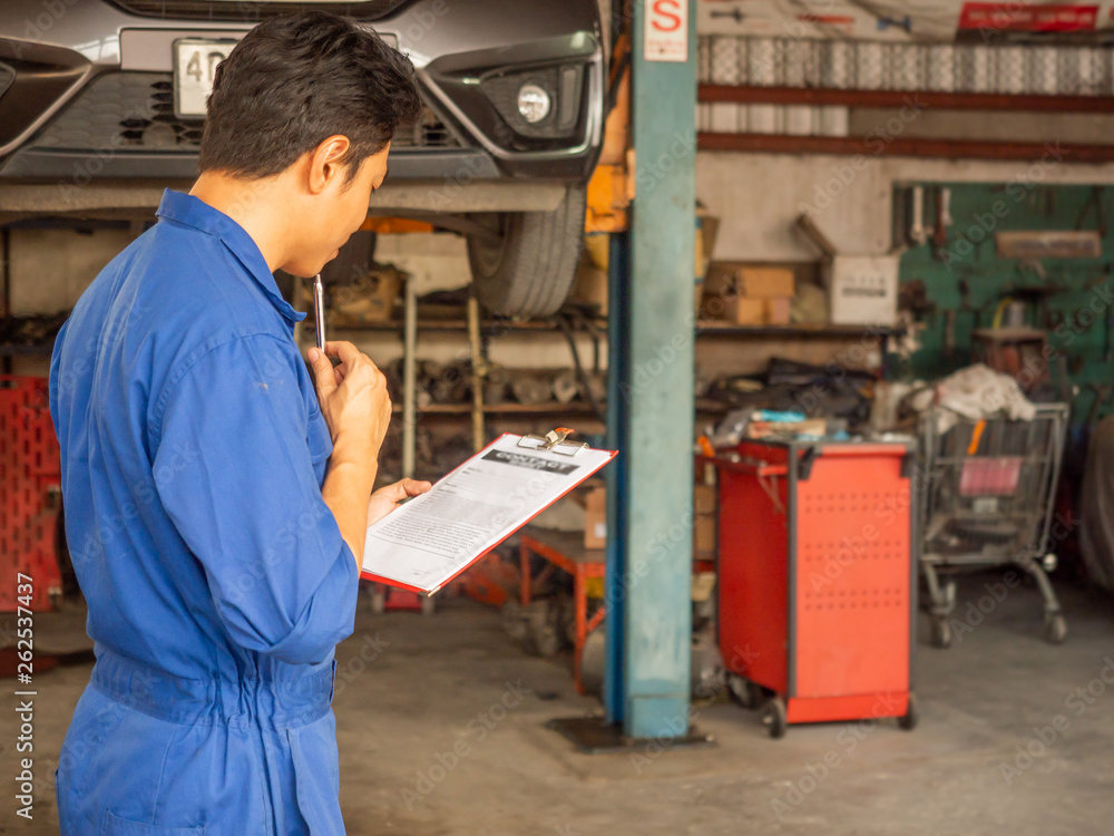 garage worker concept.Smiling happy mechanic technician worker at car repair service station garage worker concept.Smiling happy mechanic technician worker at car repair service station