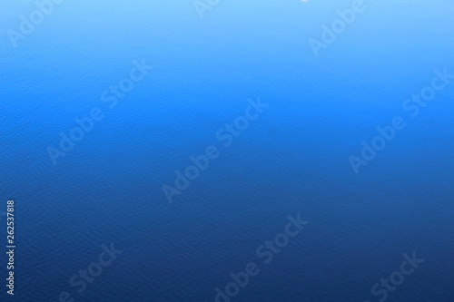 Blue background. The surface of the river with a slight ripple.