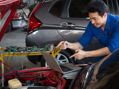 garage worker concept.Smiling happy mechanic technician worker at car repair service station