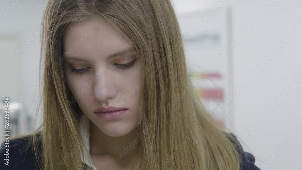 Close up portrait of sad tired young woman in formal clothes. Business lady or secretary disappointed and depressed. Difficulties in working process. Workplace. Office space. Close up portrait of sad tired young woman in formal clothes. Business lady or secretary disappointed and depressed. Difficulties in working process. Workplace. Office space.