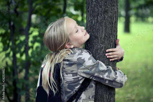 Childn embracing tree. Environmental protection outdoor nature. Conservation outdoors photo