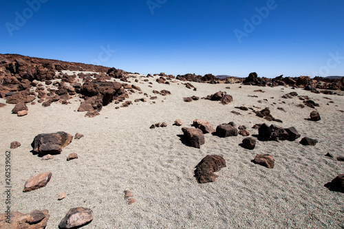 mountain desert with volcanic rocks, panorama of a rocky desert with red earth and sand