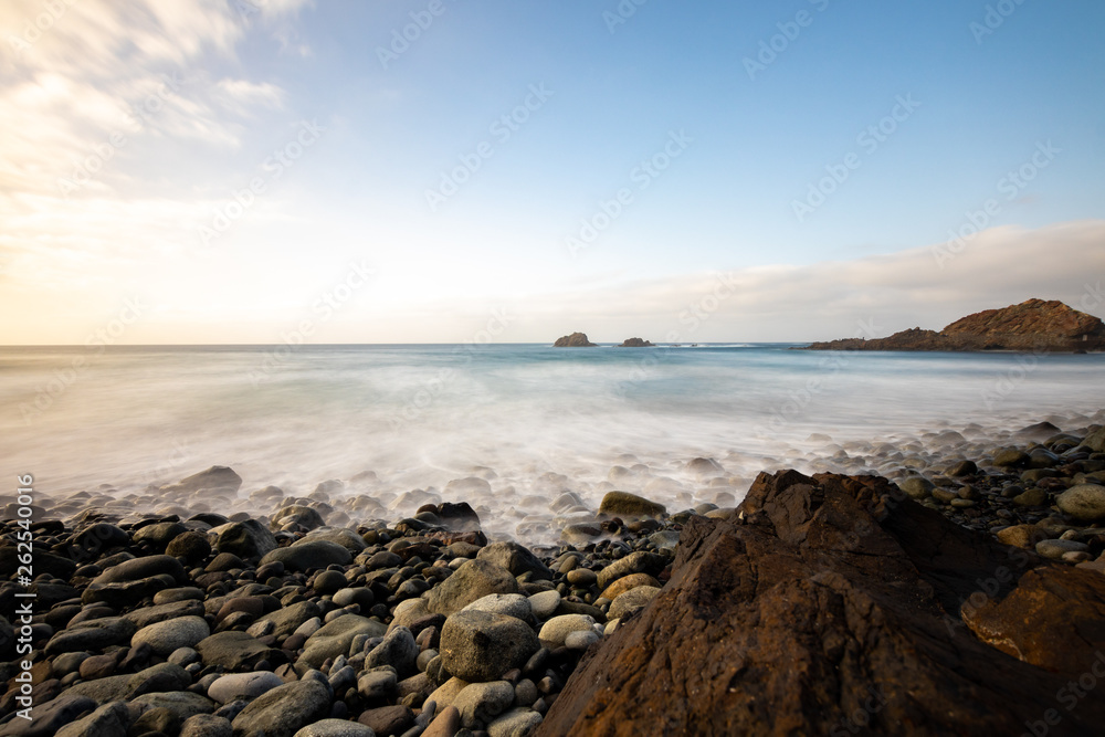 Obraz premium Sea view, marine panorama of the coast at sunset, sea, mountains, rocks, clouds and waves with soft light. Tenerife island coast and sea at sunset