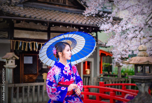 Asian woman wearing japanese traditional kimono and cherry blossom(sakura) in spring, Kyoto, Japan.