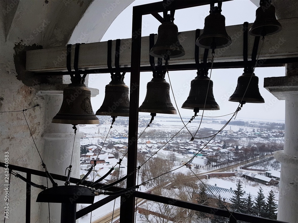 A number of different-caliber bells in the Prepodobenskaya bell tower of the rizopolozhensky monastery. Suzdal, Golden Ring, Russia, winter, a UNESCO site. Ancient architecture
