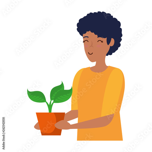 young man lifting houseplant in pot
