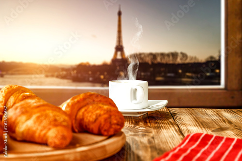 Fresh coffee with cake and Paris landscape 