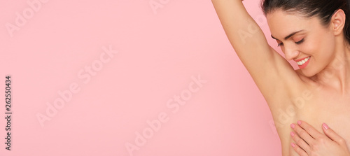 Close up of female armpit isolated on pink background. Smooth and fresh skin after shaving.