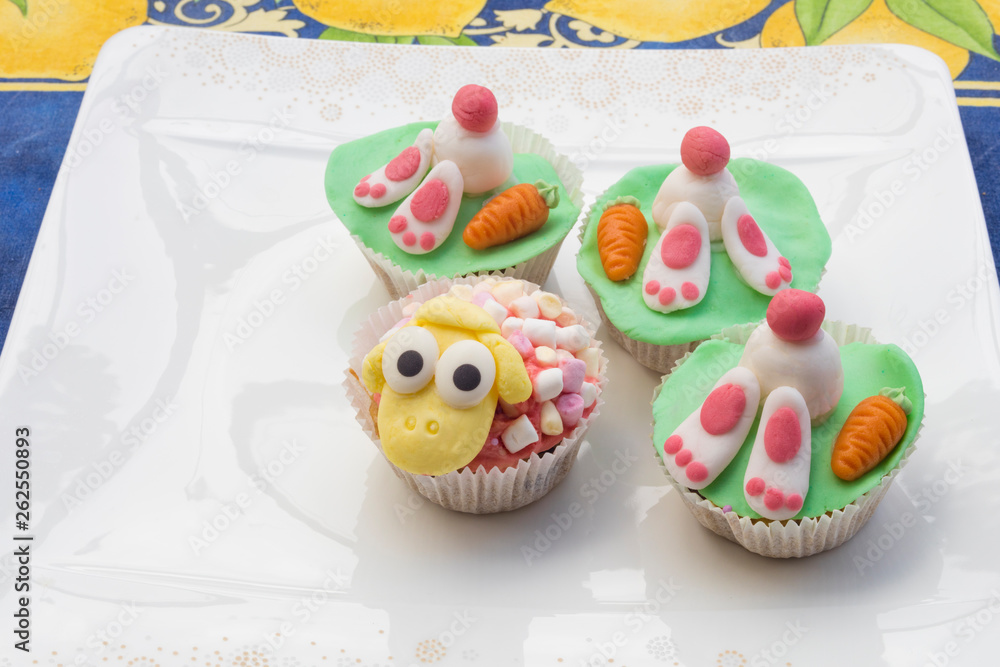Detail of funny Eastern muffins with rabbit character hiding in the ground and sheep