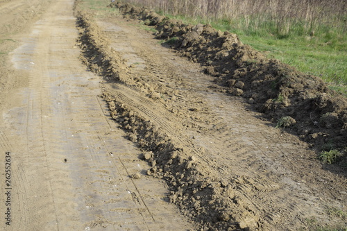 Dirt road leveled by a grader. Road in village