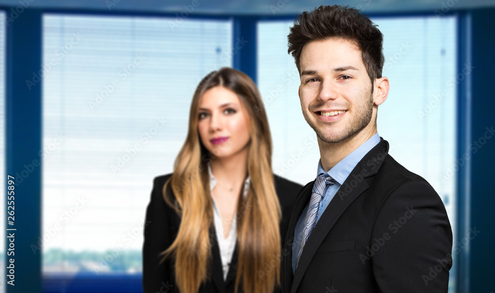 Business partners smiling in a modern office Business partners smiling in a modern office