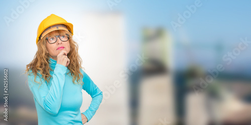 woman with construction helmet thinking © carballo
