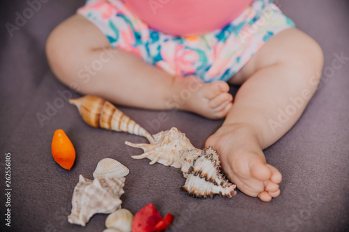 children's legs with sea shells