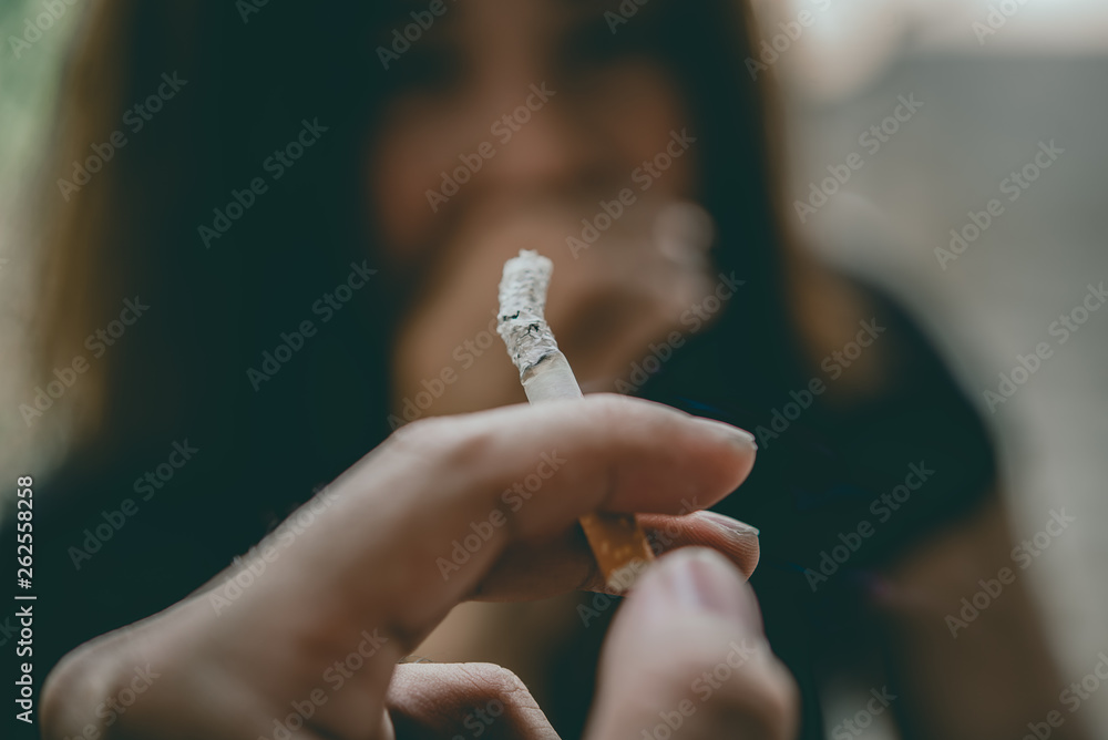 Passive smoking concept.Asian Man is smoking cigarette and woman is covering her face,No tobacco day,Smoking is objectionable to society,Thailand people