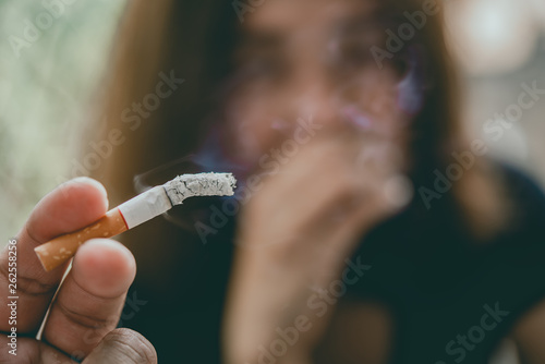 Passive smoking concept.Asian Man is smoking cigarette and woman is covering her face,No tobacco day,Smoking is objectionable to society,Thailand people photo