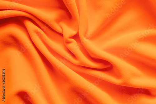 Texture of vibrant orange fleece,