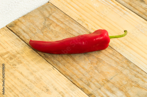 Red pepper on dirty wooden background