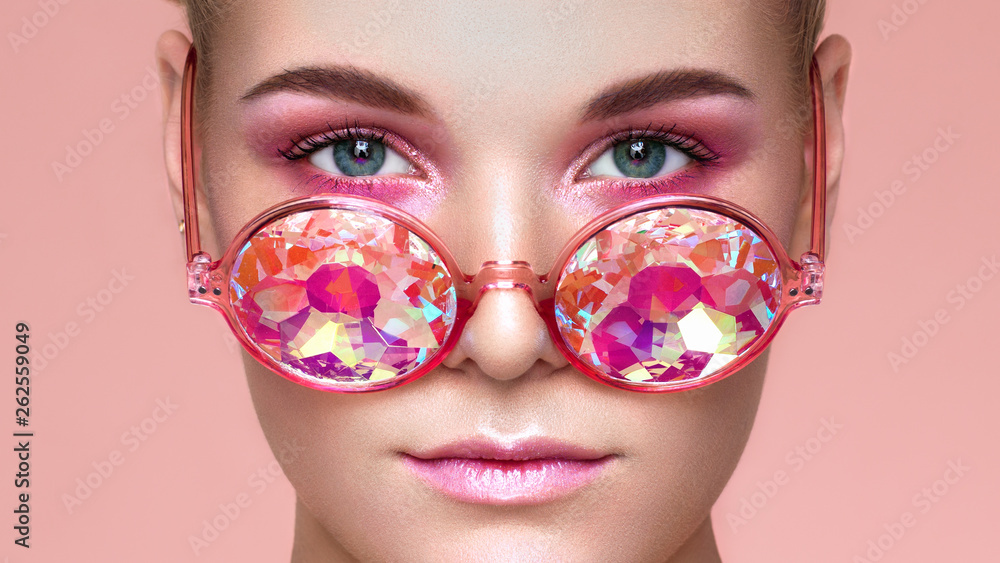 Portrait of Beautiful young Woman with Colored Glasses. Beauty Fashion. Perfect Make-up. Decoration. Holographic Coral color Stock-foto | Adobe Stock