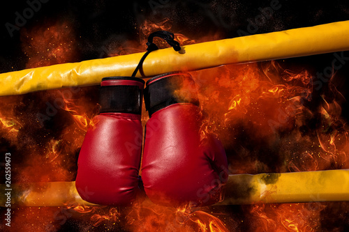 Boxing gloves hangs on flame background