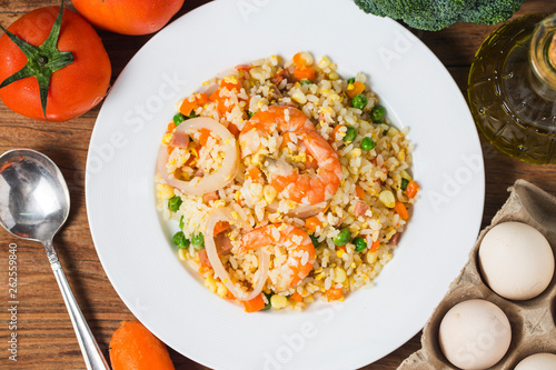 Seafood fried rice on wooden background，Thai Food ，Shrimp fried rice.