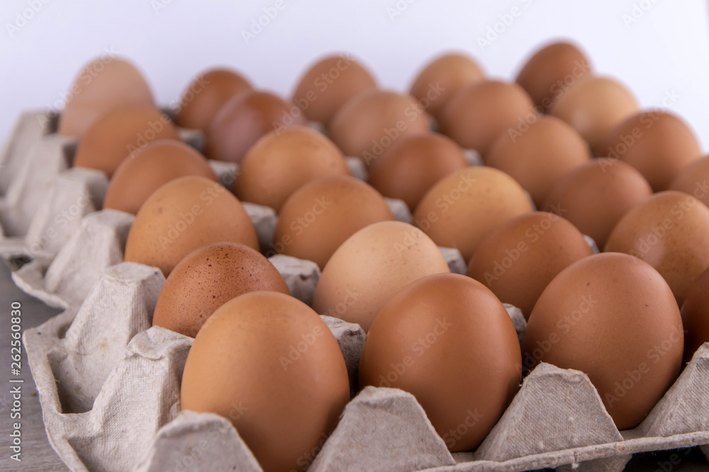 a lot of fresh red eggs in a protective cardboard tray, short focus a lot of fresh red eggs in a protective cardboard tray, short focus