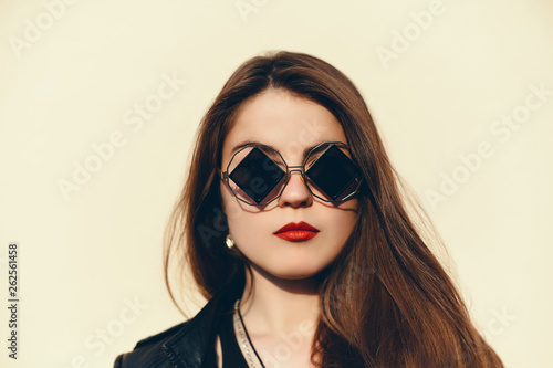 emotional portrait of Fashion stylish portrait of pretty young hipster blonde woman,going crazy,elegant black hat,soft colors,cool crazy  girl.Red urban wall background.surprised girl close up, sunset