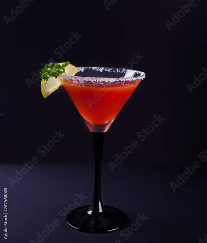 Bloody Mary Cocktail in glass. Tomato Bloody Mary spicy drink on the black background.