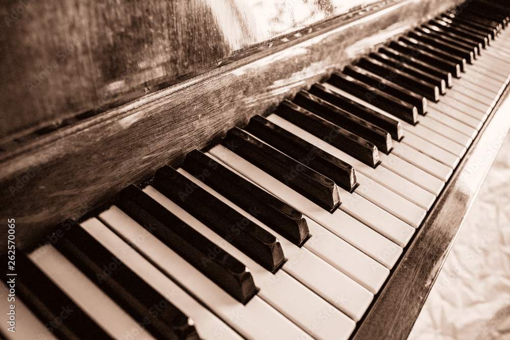The keyboard of a upright piano in sepia. Selective focus. The keyboard of a upright piano in sepia. Selective focus.