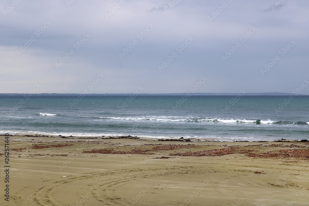 View of Mediterranean Sea with a cloudy blue sky after the rain. Waves and wind in Larnaca beach