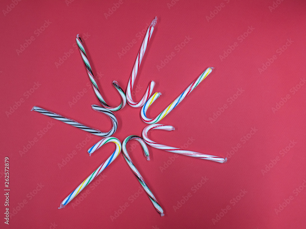 colorful caramel cane set pattern on pink background colorful caramel cane set pattern on pink background