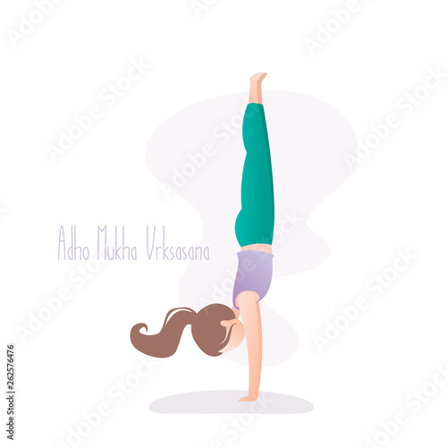 Girl doing yoga pose, Handstand or Adho Mukha Vrksasana asana in hatha yoga,