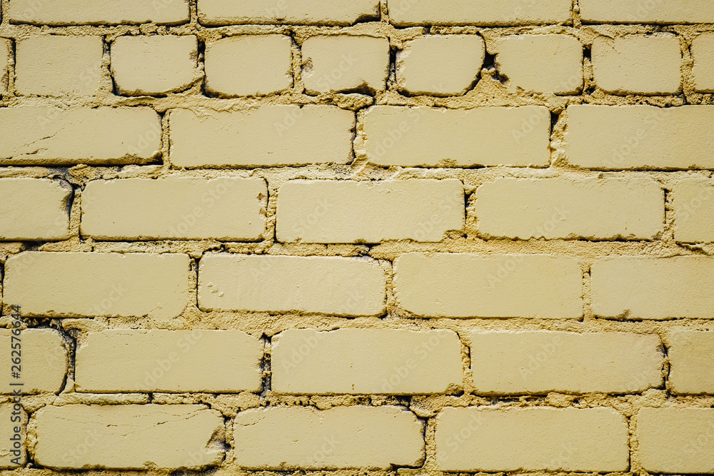 horizontal part of bright yellow painted brick wall horizontal part of bright yellow painted brick wall