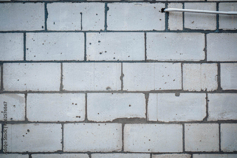 Fototapeta premium Wall is made from bricks and painted with white color.