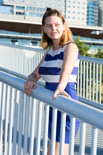 Girl posing on city bridge in summer day © JackF