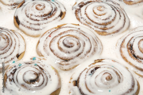 Baked cinnamon buns were poured over with a white icing to soak