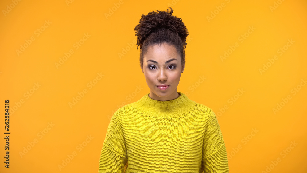 Curious pretty female in yellow sweater on bright background, youth fashion Curious pretty female in yellow sweater on bright background, youth fashion