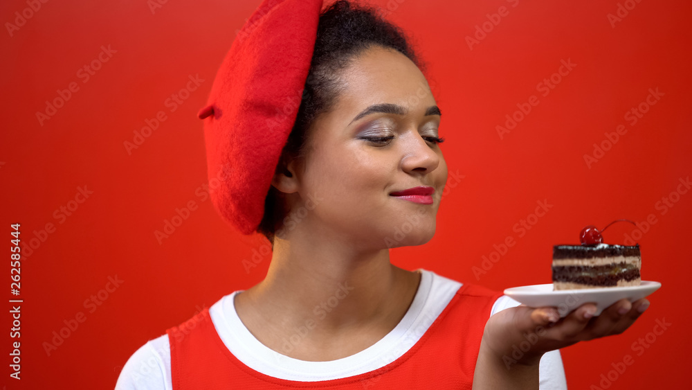 Young woman looking at tasty chocolate cake with red cherry, dessert pleasure Young woman looking at tasty chocolate cake with red cherry, dessert pleasure