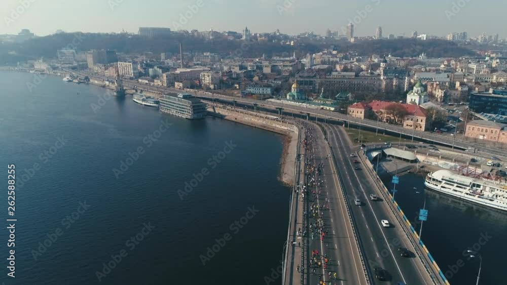 Marathon running on the bridge. City background. Wide shot Marathon running on the bridge. City background. Wide shot