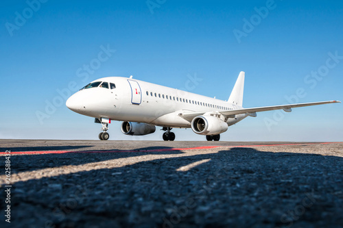 White passenger jet plane on the airport apron © Dushlik