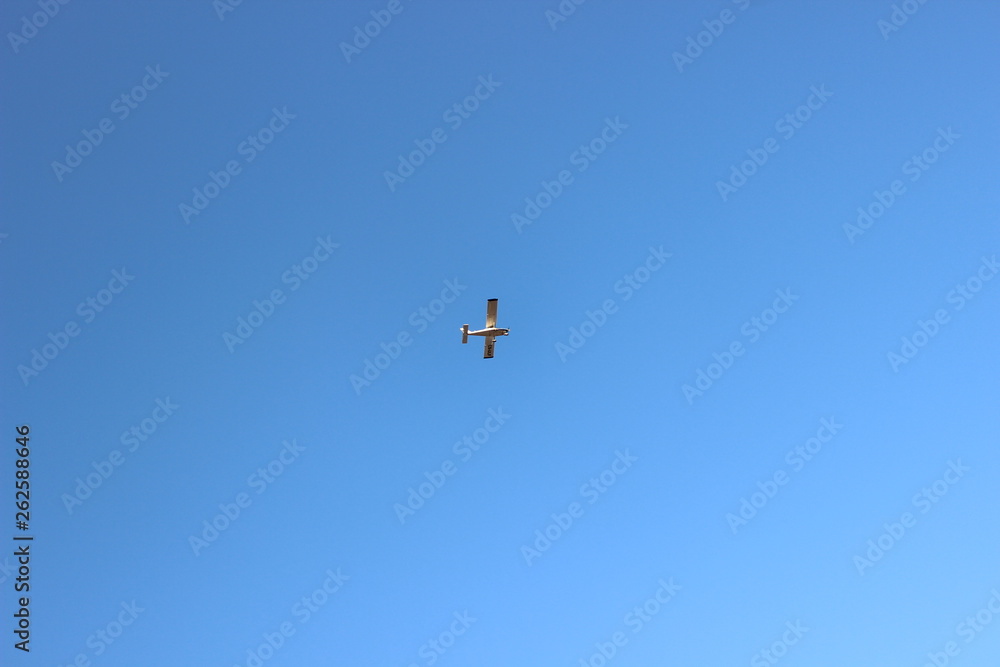 Propeller airplane flying in the sky without clouds
