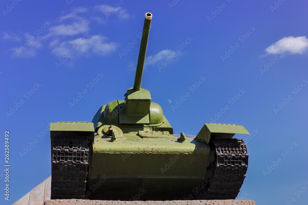 Fototapeta premium Soviet tank T-34 at war in the second world war on a blue sky background.