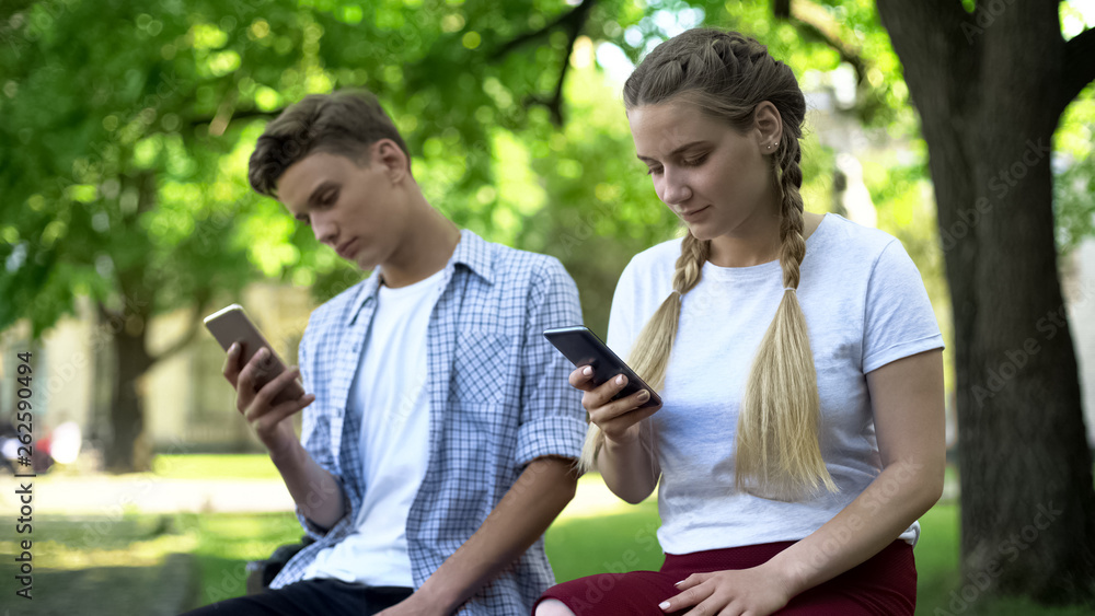 Teenagers using phone instead of interacting, lack of communication, addicted Teenagers using phone instead of interacting, lack of communication, addicted